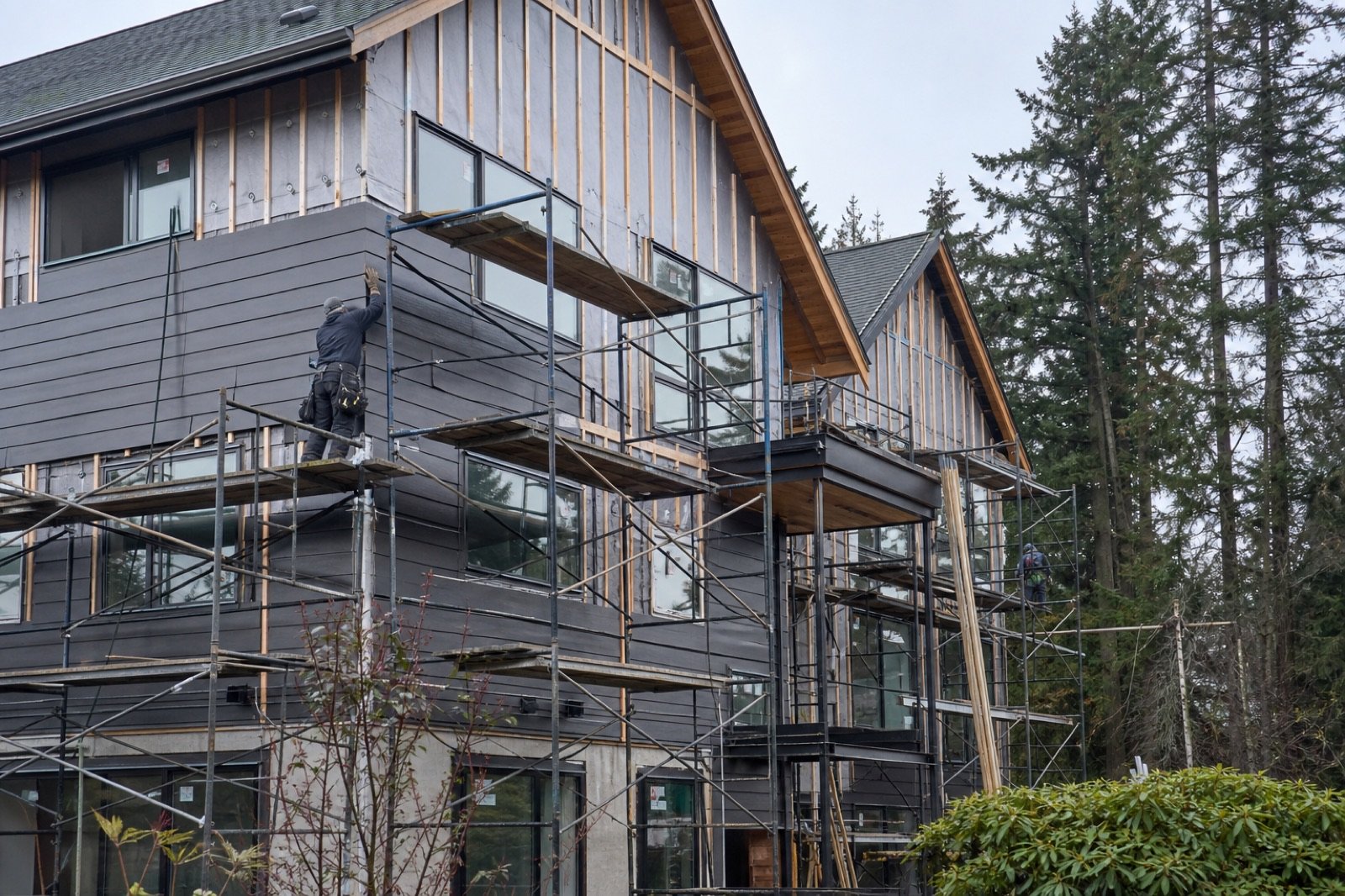 Multi-family building exterior with scaffolding during rainscreen cladding restoration