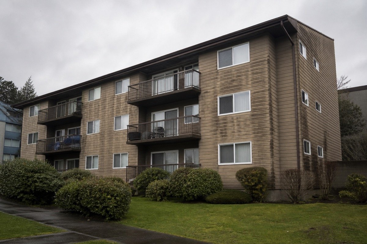 Full cladding replacement — 4-storey multi-family — before